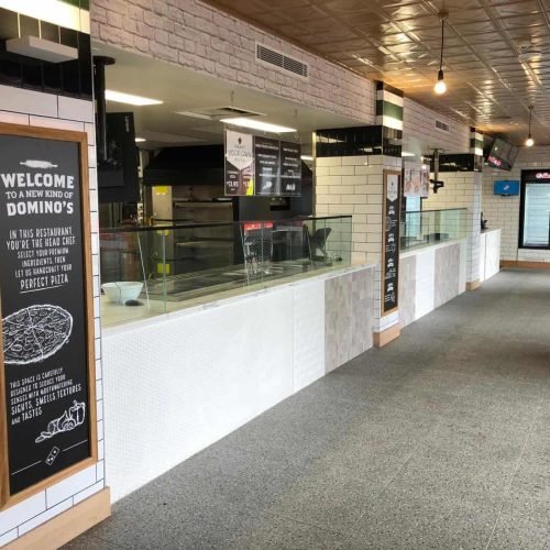 Modern Domino's pizza restaurant interior with clean design and branding.